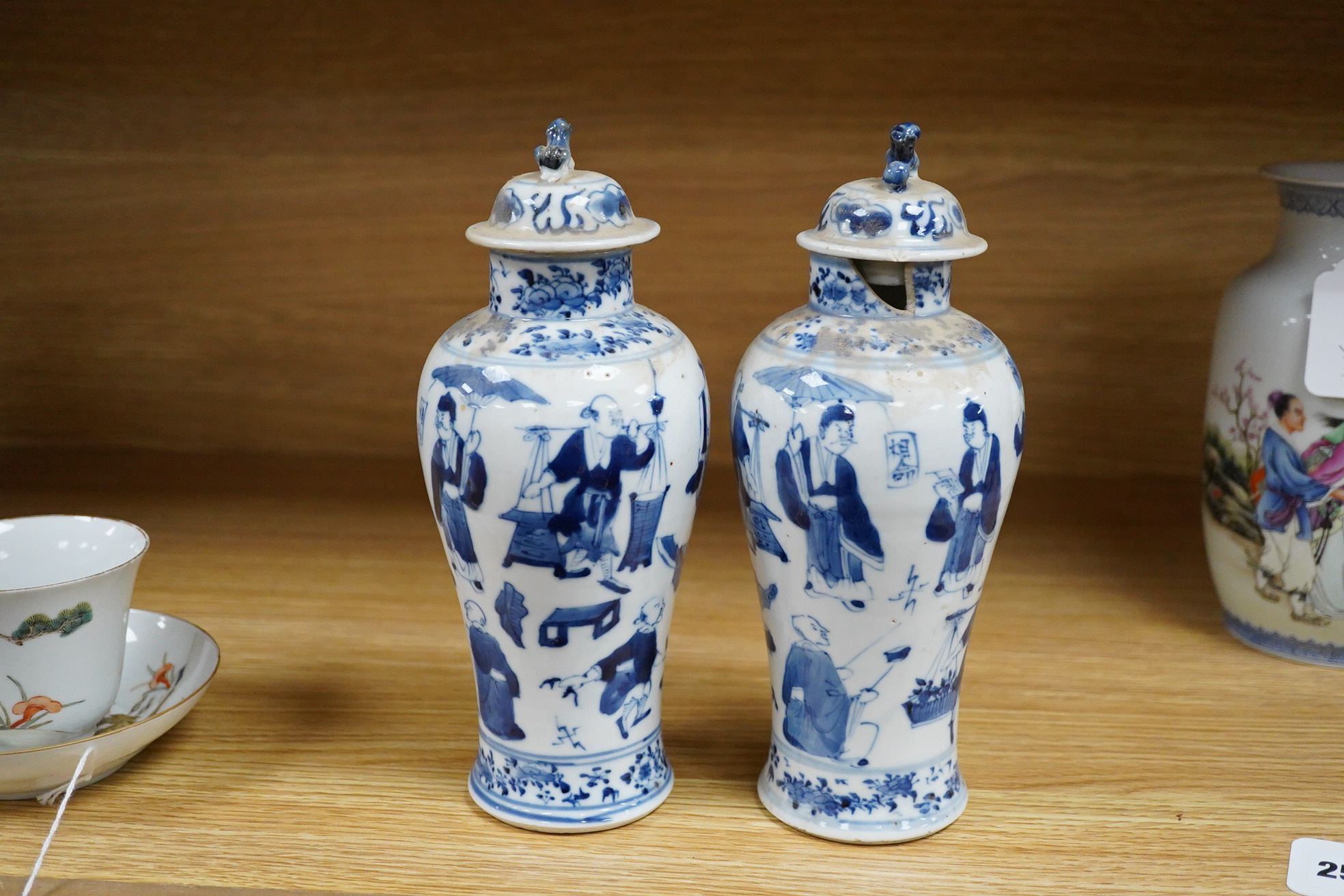 A pair of 19th century Chinese blue and white vases and covers. 22.5cm high
